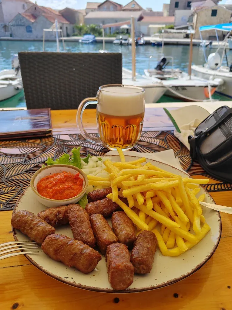 Ćevapi s pomfritom uz pogled na luku